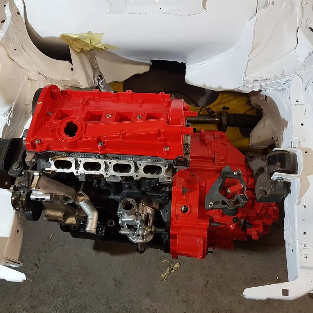 Freshly painted red engine and gearbox assembly