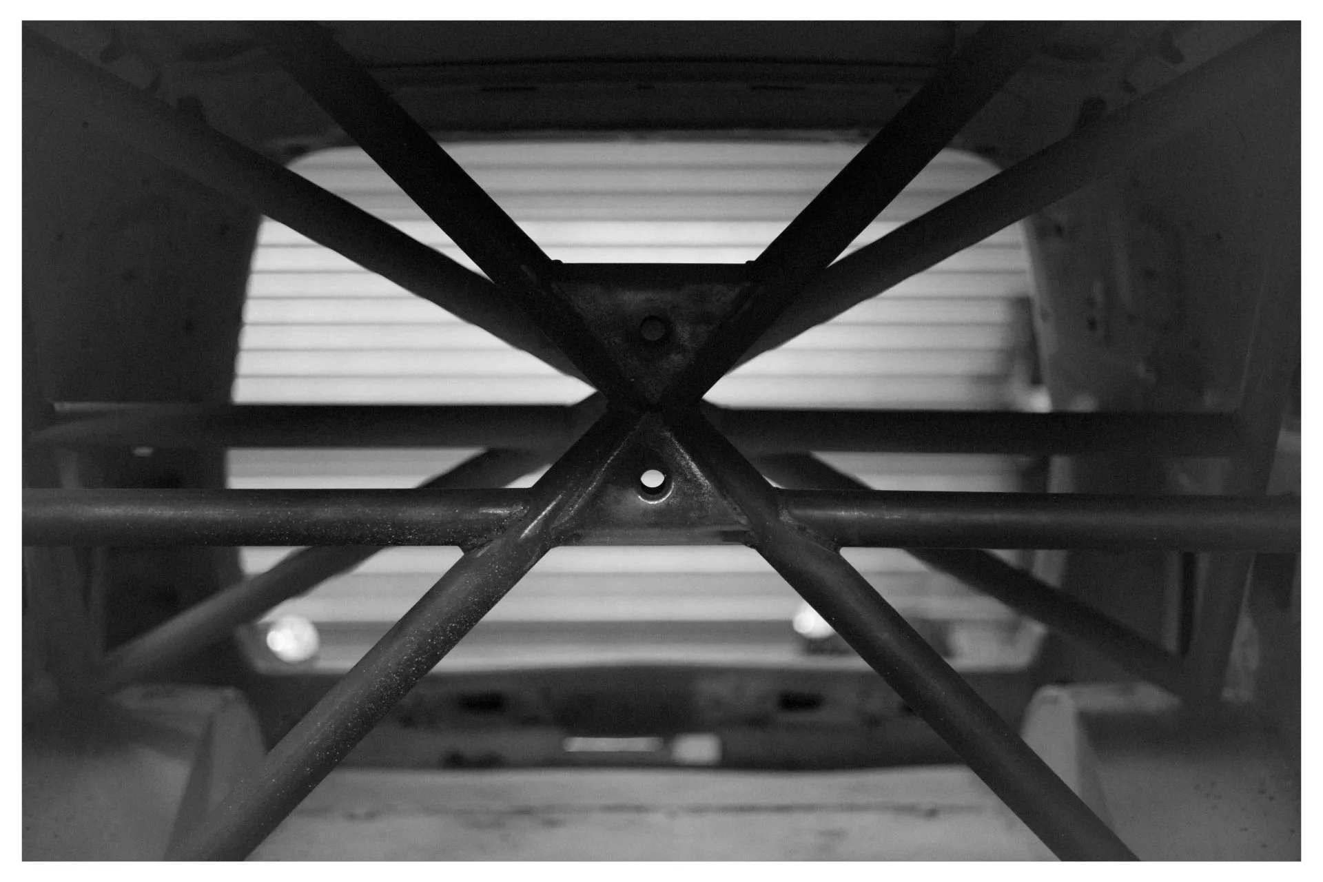 Close-up of welded roll cage X-brace structure