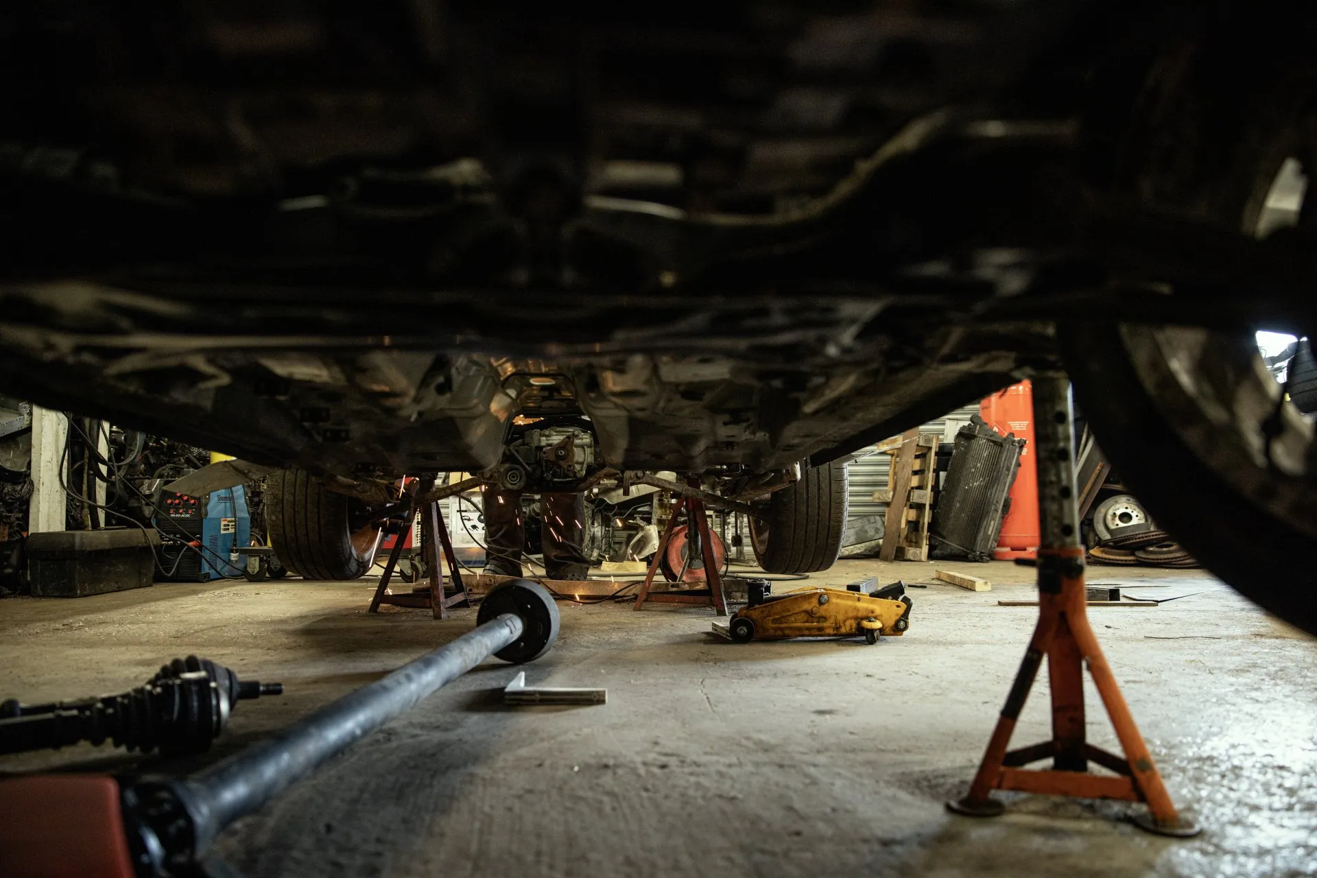 Underbody view of vehicle on axle stands during repair