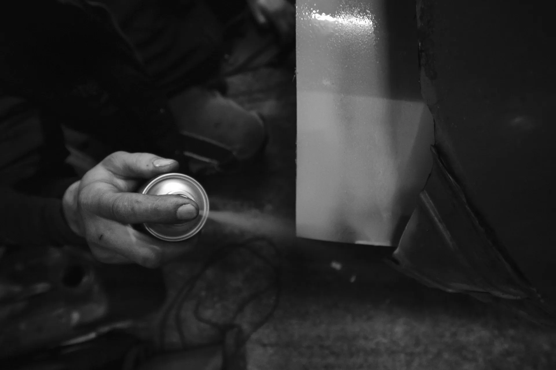 Black and white detail of spray priming bodywork