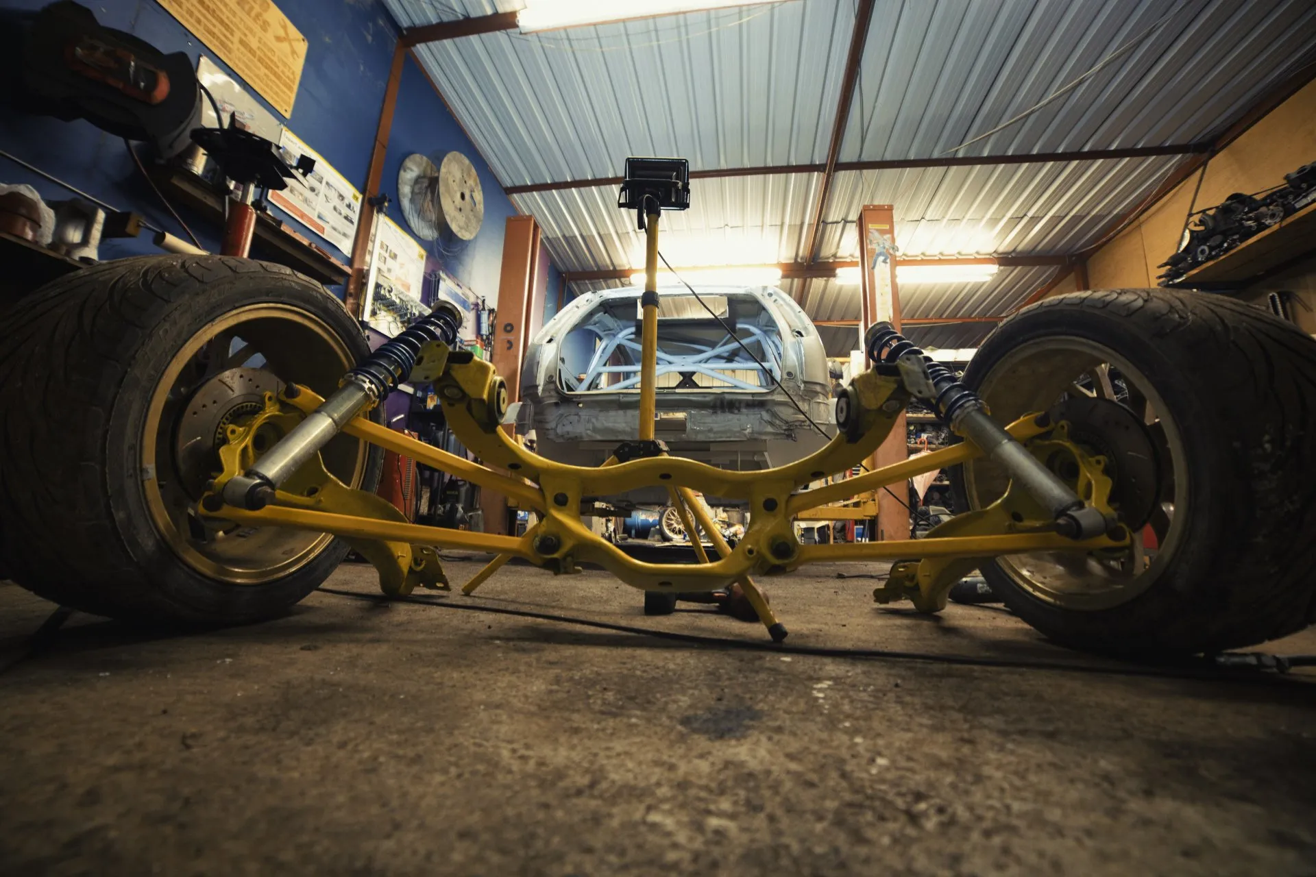 Rear subframe and suspension assembly in front of stripped shell