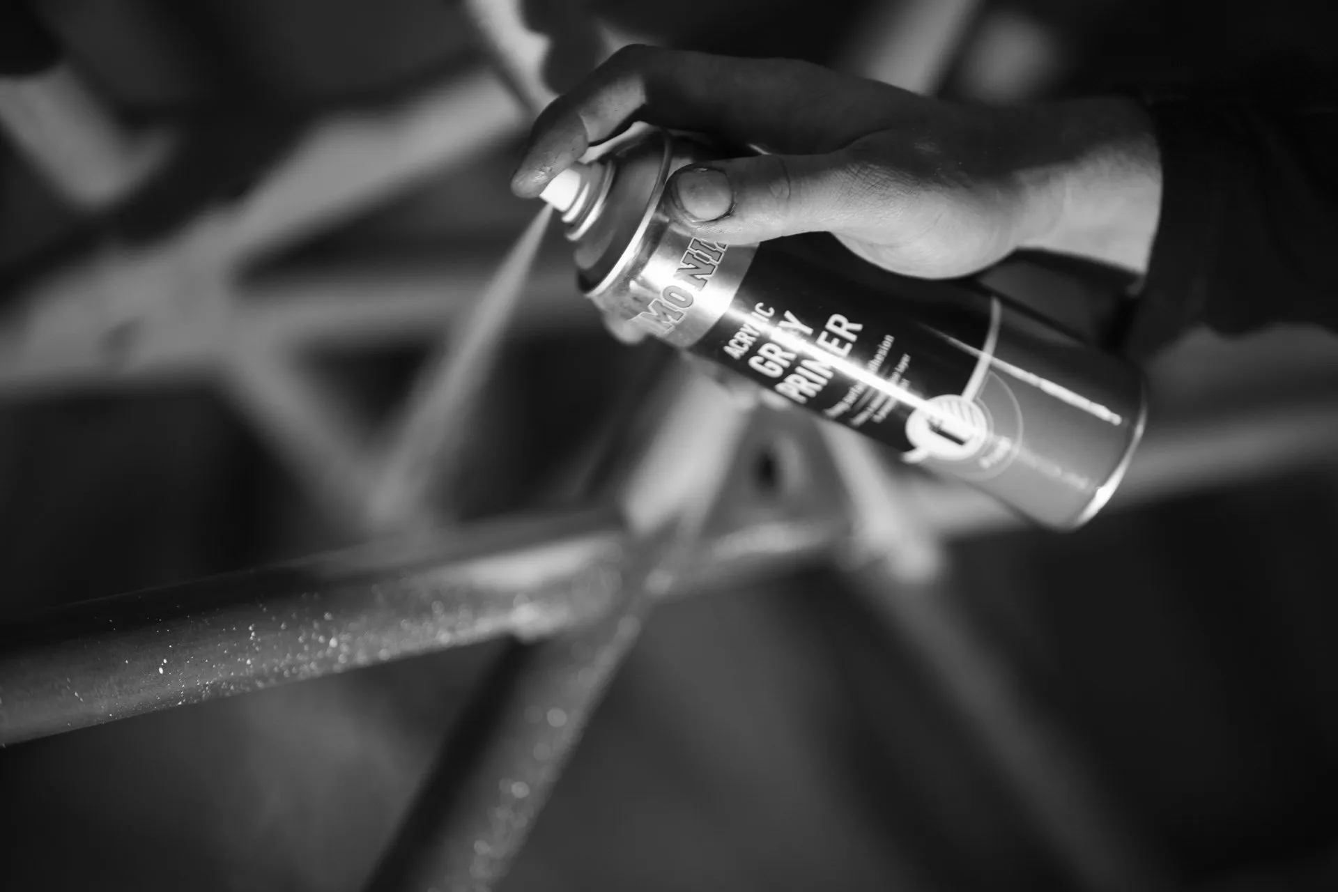 Hand spraying primer onto roll cage tubing