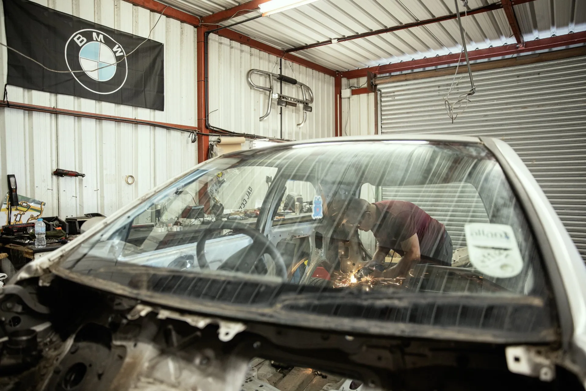 BMW workshop bay with stripped shell in progress